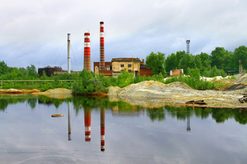 Reflection of two smokestacks in a lake