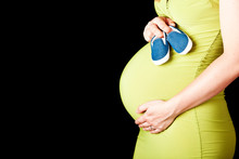 Pregnant Woman With Baby Shoes