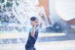© Creativa Images - Cute asian boy playing at waterpark