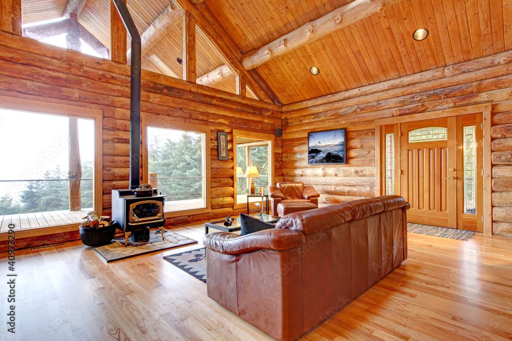 Luxury log cabin living room with leather sofa. Stock Photo | Adobe Stock