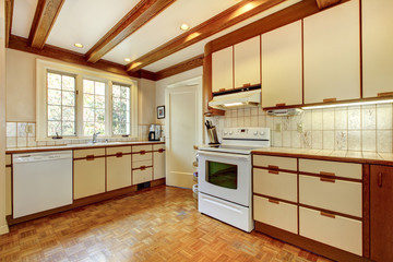 Old simple white and wood kitchen with hardwood floor.