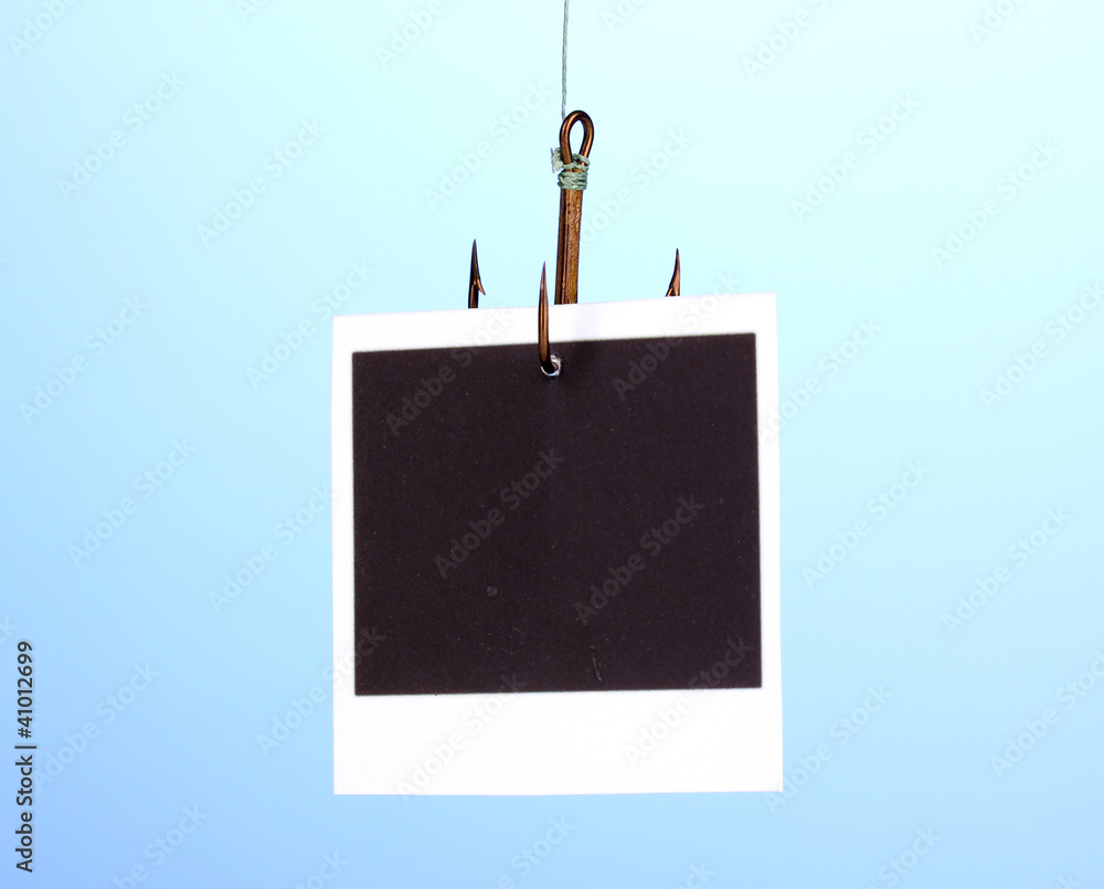 Photo on fish hook on blue background