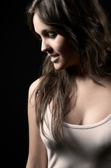 Studio shot of beautiful young woman whit white top in black bac