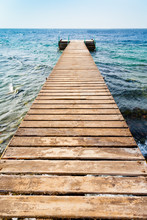 Wooden Pier On Coast Of Coral Beach