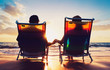 © EpicStockMedia - senior couple of old man and woman sitting on the beach watching