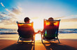 © EpicStockMedia - senior couple of old man and woman sitting on the beach watching