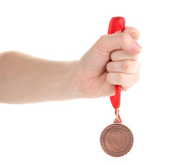 Bronze medal in hand isolated on white