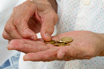 Wall Mural - Hands of an old woman with coins