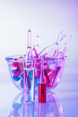 Wall Mural - Medical ampoules still life in vivid violet colors