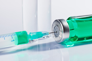 Ampoule and syringe macro still life on white