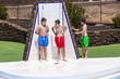 © travelview - boys have fun unter the pool shower