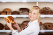 © contrastwerkstatt - bäckereiverkäuferin mit brot am regal