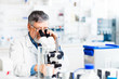 © lightpoet - senior male researcher carrying out scientific research in a lab