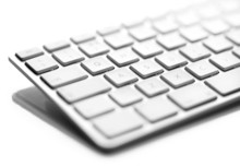 A Close Up Of A White Computer Keyboard