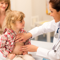 Wall Mural - Pediatrician examine child tummy at office