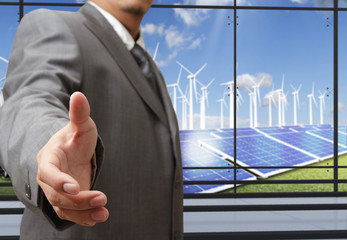 Wall Mural - business man offers hand shake with energy saving