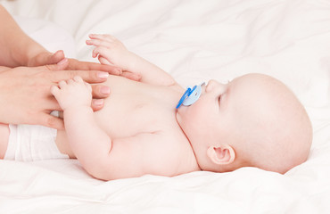 Mother massaging  baby