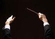 Concert conductor's hands with a baton