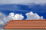 Fototapeta  - Roof tiles and blue sky with clouds