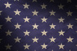 Stars in a field of blue on an American flag lit diagonally