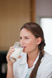 © WavebreakmediaMicro - Woman drinking a glass of milk while looking away