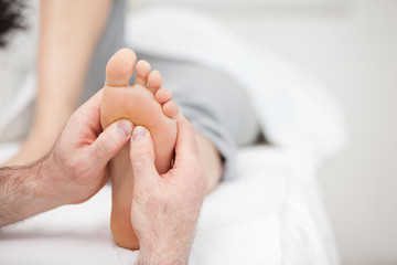 Foot being massaged on a medical table