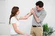 © WavebreakmediaMicro - Serious practitioner touching the elbow of a woman