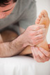 © WavebreakmediaMicro - Serious physiotherapist making a joint mobilisation