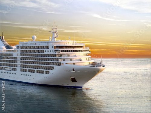 Fototapeta dla dzieci Luxury cruise ship sailing from port on sunset