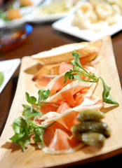 Slices of prosciutto di Parma, italian cured ham served as appet