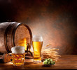 © volff - Beer barrel with beer glasses on a wooden table.