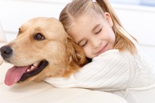 Cute Little Girl And Dog Embracing