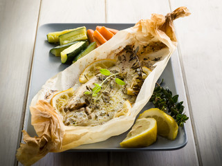 Sticker - sole fish cocked in a wrapper with herbs and sliced lemon