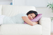 © WavebreakmediaMicro - Woman sleeping on a couch with a pillow
