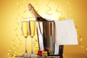 Wall Mural - Champagne bottle in bucket with ice and glasses of champagne,