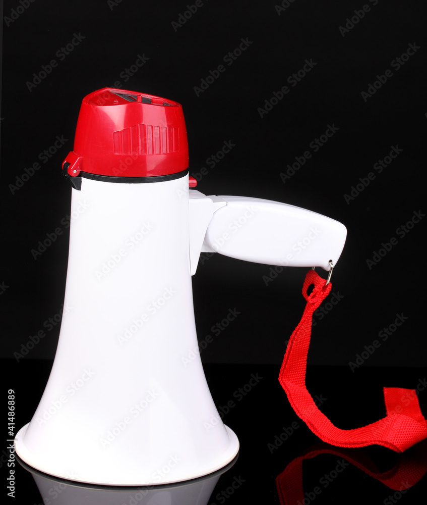 red and white megaphone isolated on black