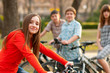 © Solid photos - Beautiful teenage girl with her friends riding bicycles