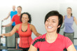 © CandyBox Images - Smiling woman at fitness class gym workout