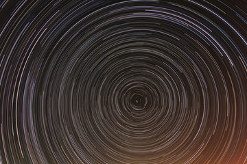 Cumulative time lapse of star trails in night sky.