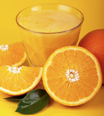 Canvas Print - Orange juice and slices of orange isolated on yellow