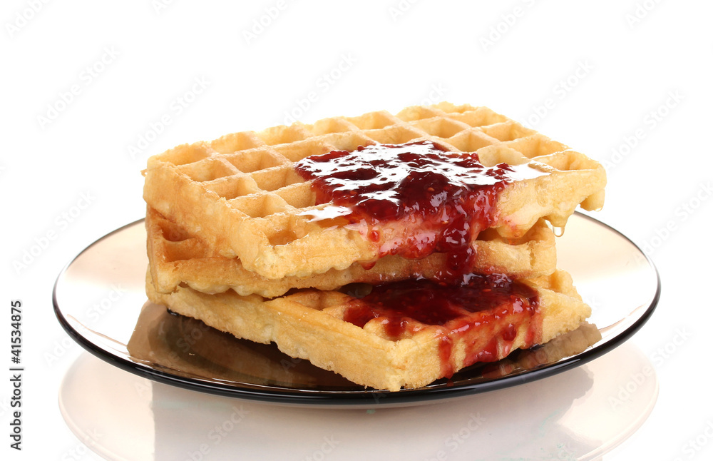 Tasty waffles with jam on plate isolated on white