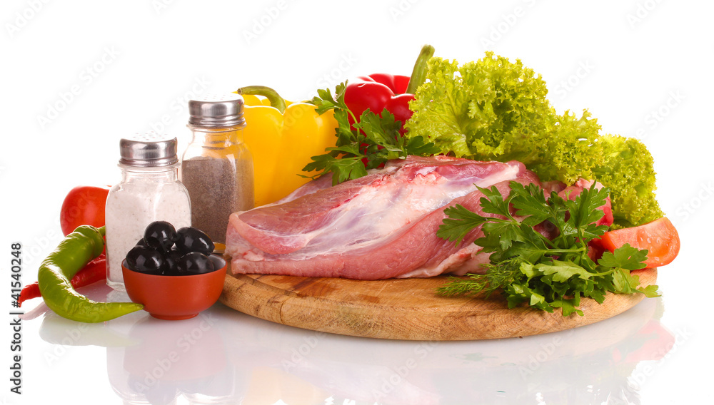 Raw meat and vegetables on a wooden board isolated on whitе