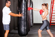 © michaeljung - fitness woman training with punch bag in gym