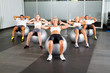 © michaeljung - group of people doing workout with fitness balls in gym