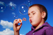 © waltkopp - child blowing soap bubbles
