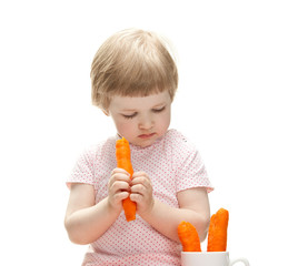 Little baby eating fresh carrot