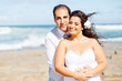 loving newlywed couple on beach