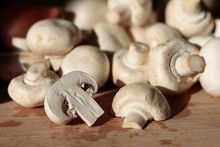 White Mushrooms On A Wooden Chopping Board