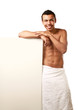 © lenets_tan - A nude young man covering himself with a towel