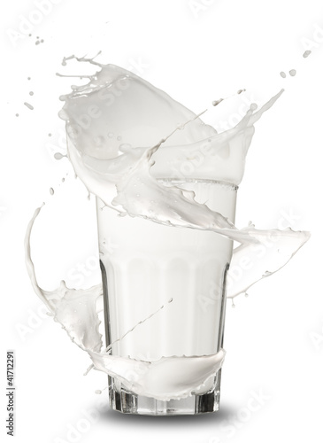 Fototapeta na wymiar Milk splashing out of glass, isolated on white background